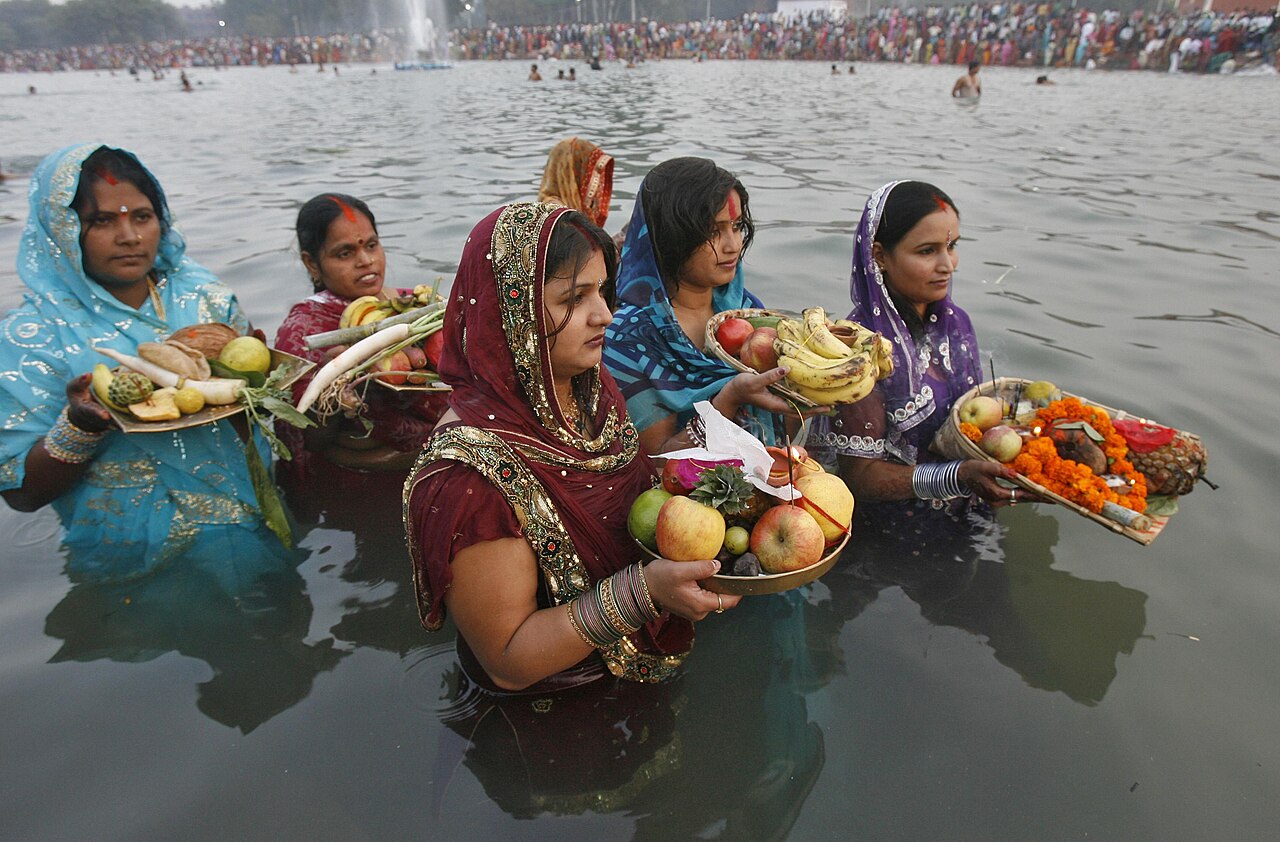 Devotees making Chhath offerings at the river in Bihar